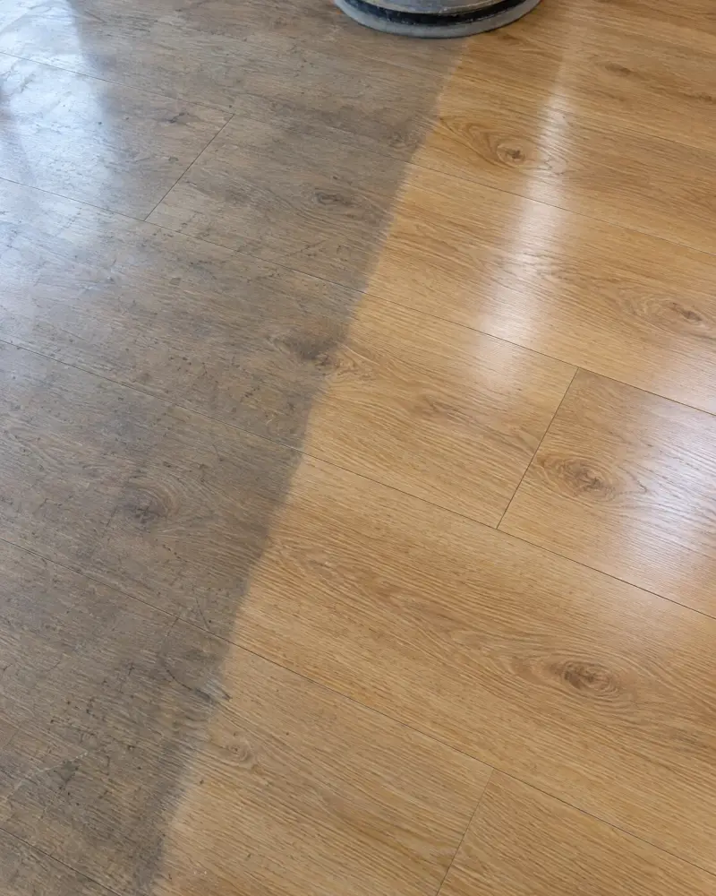 Close, detailed shot of a stone or LVT floor mid-treatment